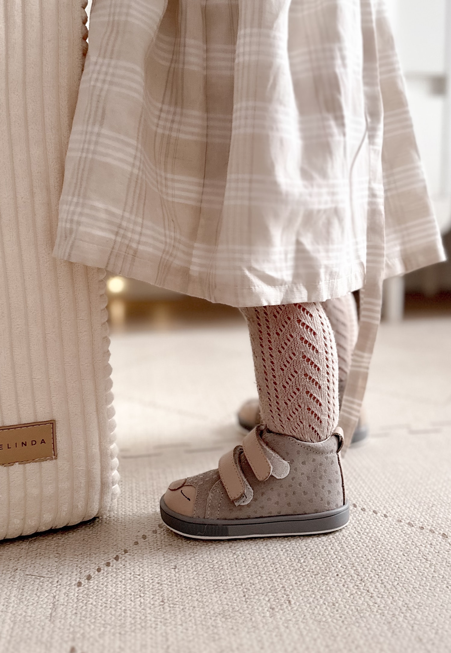 Beżowo-złote trzewiki dziecięce i dziewczynka w sukience